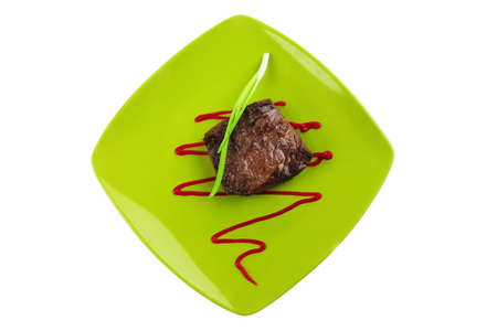 meat savory : grilled beef fillet mignon served on green plate isolated over white background with chives and ketchupの写真素材