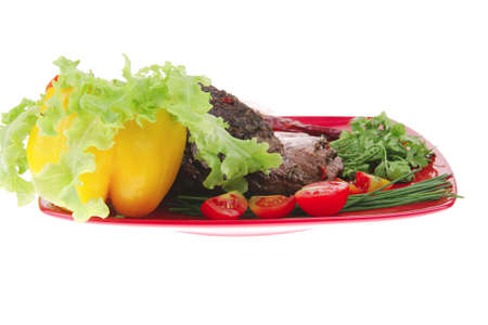 beef slice on red plate and vegetablesの写真素材