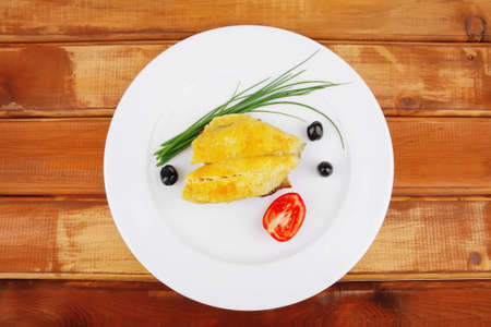 savory: fish fillet served on plate over wood with tomatoes,olives and bread の写真素材