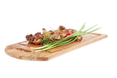 meat : grilled quarter chicken garnished with green sprouts and red peppers on wooden plate isolated over white backgroundの写真素材