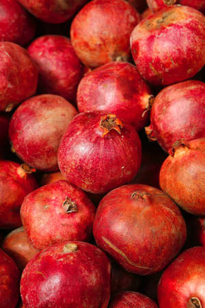fresh raw lot of pomegranate on counterの写真素材
