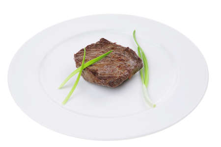 meat food : roast beef fillet mignon served on white plate with green sprouts isolated over white backgroundの写真素材