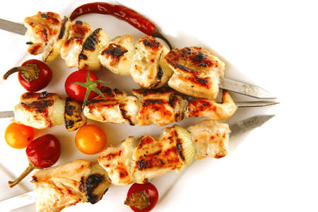 fresh roast chicken shish kebab on white platterの写真素材