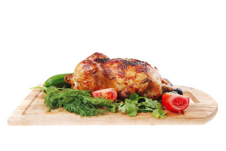 baked meat : homemade turkey with black olives and raw tomatoes on wooden board isolated over white backgroundの写真素材