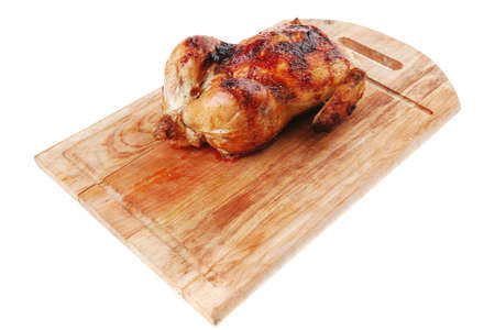 poultry : homemade roast whole turkey on wooden cutting board isolated over white backgroundの写真素材