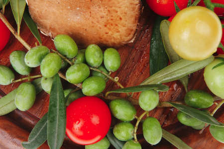 uncooked raw vegetables on wooden plate over whiteの写真素材
