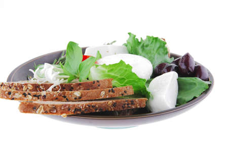 mozzarella cheese with olives and bread on dishの写真素材