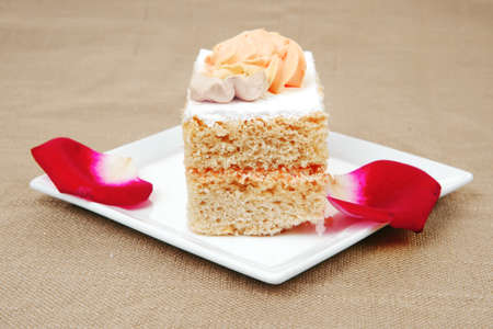 sweet food: tender cream cake served with roseの写真素材