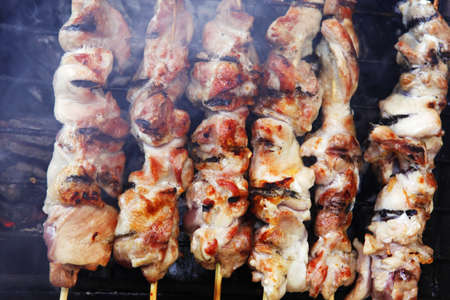 shish kebab on grilling grid over barbecue charcoalの写真素材