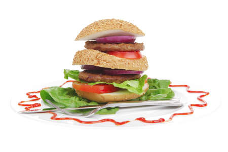 big double grilled hamburger on ceramic plate isolated  over white backgroundの写真素材