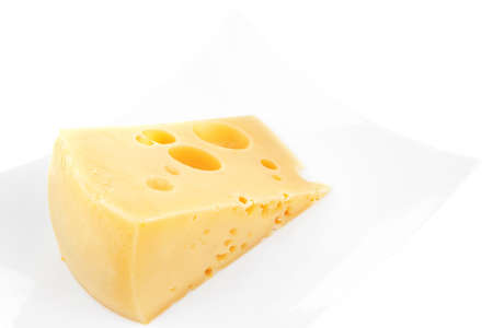 french gourmet triangle of parmesan yellow cheese  on a plate isolated over white backgroundの写真素材