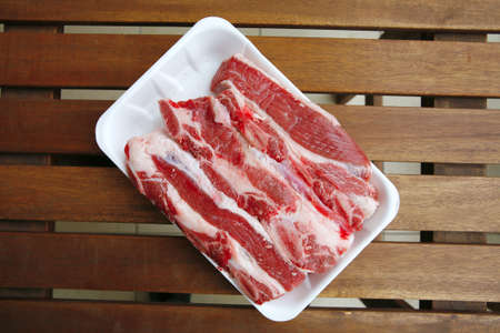image of raw ribs on wooden tableの写真素材