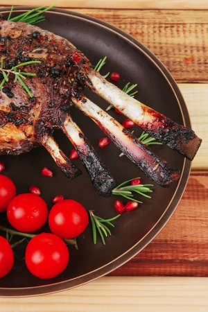 served charbroiled ribs on plate with vegetablesの写真素材