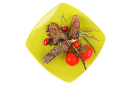 meat savory: roast ribs on green plate with peppers and chivesの写真素材