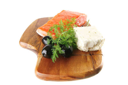 smoked fresh salmon piece with olives and white cheeseの写真素材