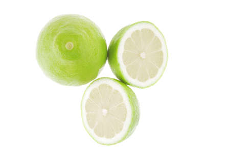 fresh raw lime isolated over white backgroundの写真素材