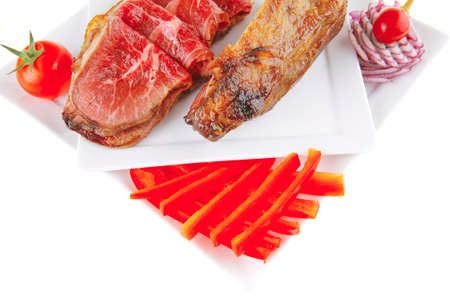 fresh roasted meat rolls and chunk on white platterの写真素材