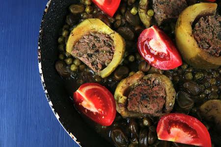 homemade cuisine: zucchini filled meat on peas and beans cooked into pan