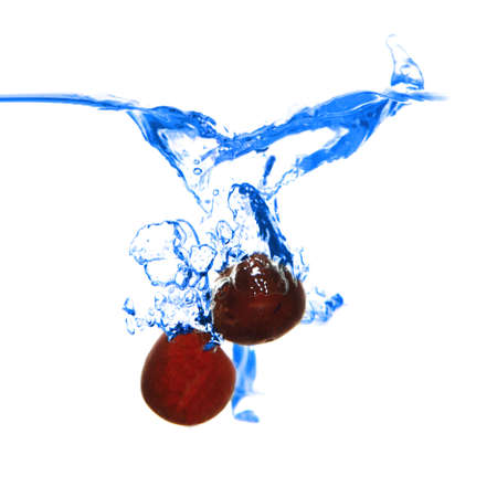 smal red cherry fal in blue waterの写真素材