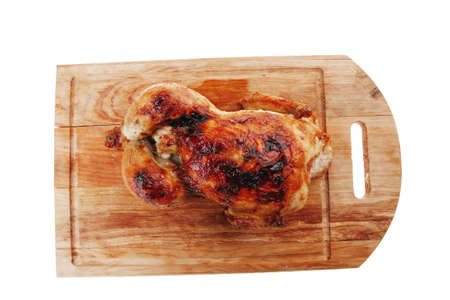 poultry : fresh grilled whole chicken on wooden cutting board isolated over white backgroundの写真素材