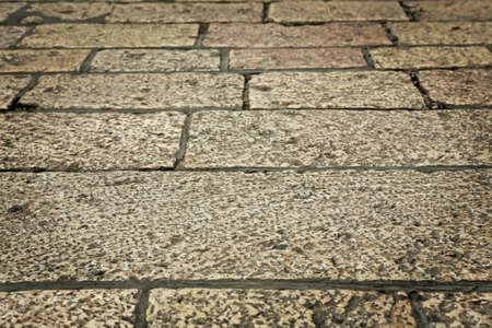 old style aged cracked vintage stone wall as backgroundの写真素材