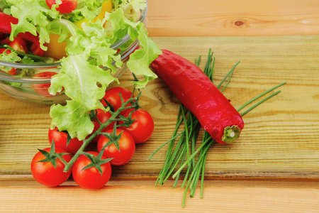 fresh salad and cherry's on wooden tableの写真素材
