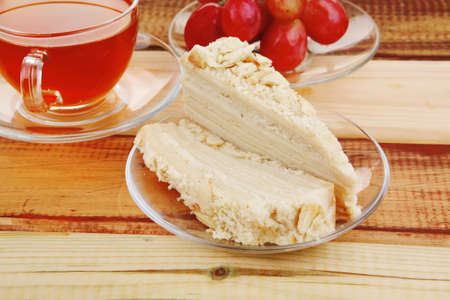 cake dessert and tea and grapes on wood