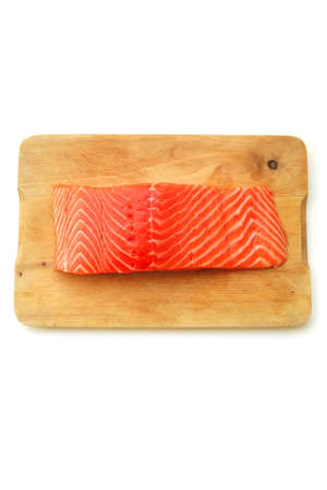 raw salmon fish piece on wooden tray isolated on white background