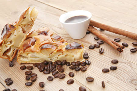 baked food : apple pie triangles served with hot coffee cup on wood tableの写真素材