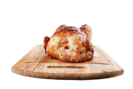 poultry : homemade roast whole turkey on wooden cutting board isolated over white backgroundの写真素材