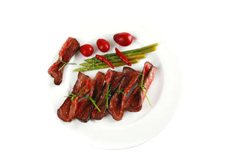 beef meat and red spices on white plateの写真素材