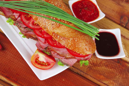 sandwich : fresh white french baguette with chicken smoked sausage on woodの写真素材