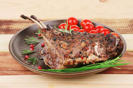 served charbroiled ribs on plate with vegetablesの写真素材