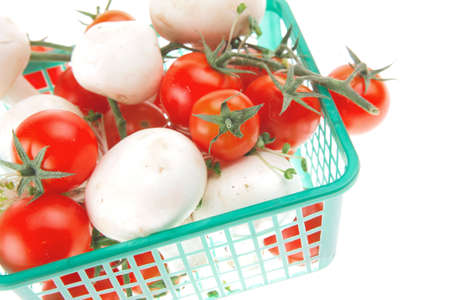 white mushroom and cherry in small green basketの写真素材