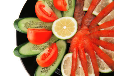 smoked salmon and vegetables served on plateの写真素材