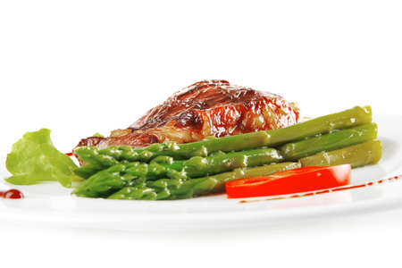 roasted beef meat served with asparagus on plateの写真素材