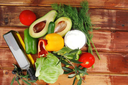 prepared vegetables on wood with sour creamの写真素材