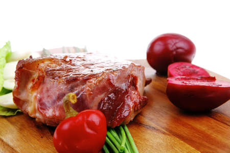 meat savory : beef fillet mignon grilled and garnished with green lettuce and red chili hot pepper on wooden plate isolated over white backgroundの写真素材