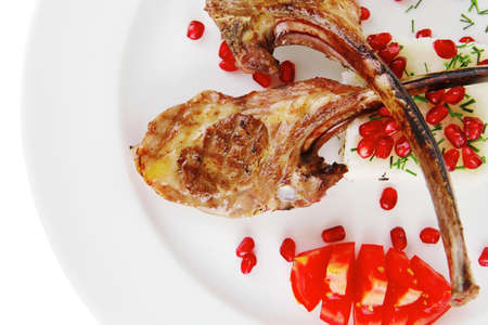 meat portion: barbecued ribs served with rice and tomatoes on plate over white backgroundの写真素材