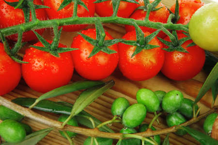 fresh raw vegetables on wooden board over whiteの写真素材