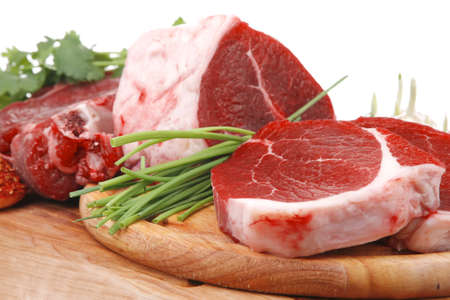 raw meat : fresh beef pork big rib and fillet with garlic and green stuff on wood isolated over...