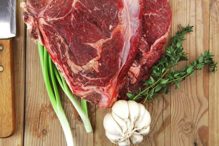 raw meat : boned fresh lamb ribs served with thyme , garlic and red chili pepper on wooden boardの写真素材