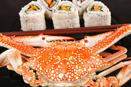 Roll with Cucumber , Cream Cheese with raw Tuna and Salmon inside. on black dish with boiled crab . Japanese traditional Cuisineの写真素材