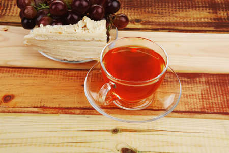 cake dessert and tea and grapes on woodの写真素材