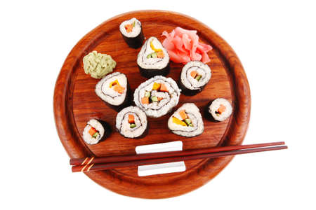 Maki Sushi : Maki Rolls and California rolls made of fresh raw Salmon(sake), Tuna(maguro) and Eel(unagi) . on wooden plate with wasabi and ginger isolated over white backgroundの写真素材