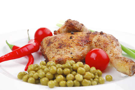 meat savory : chicken legs  grilled and garnished with green onion and red chili hot pepper on white plate isolated over white backgroundの写真素材