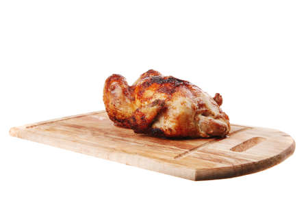poultry : fresh grilled whole chicken on wooden cutting board isolated over white backgroundの写真素材