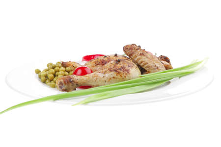 meat food : roast chicken garnished with green onion and red chili hot pepper on white plate isolated over white backgroundの写真素材