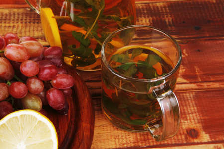 raw fruits served with tea on woodの写真素材