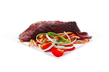 meat and potato : rare grilled beef steak served with pepper and tomato over plate isolated on white backgroundの写真素材